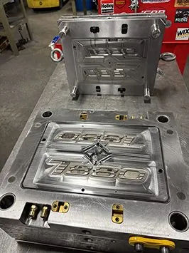 Mold core and cavity halves on a bench at D&M Tool